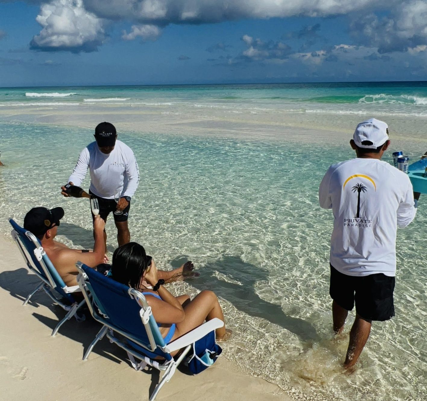 Private Paradise Villa butler serves champagne on Cozumel beach